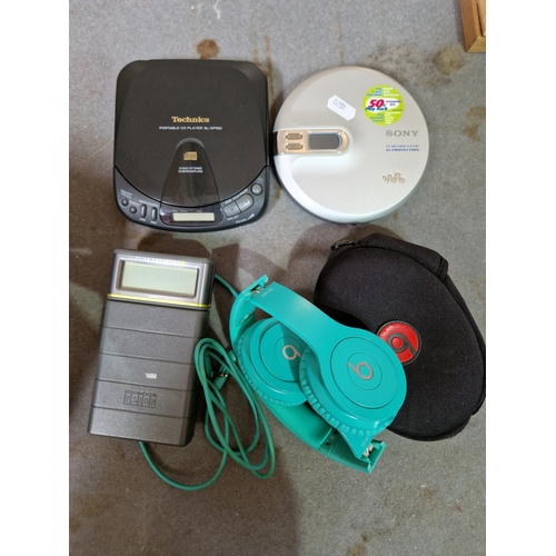 336 - A Sony Walkman together with a Technics portable CD player, a Psion Organiser and a pair of Beats by... 