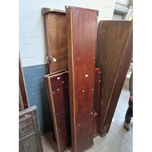 934 - An Edwardian inlaid mahogany glazed bookcase, requires assembly.