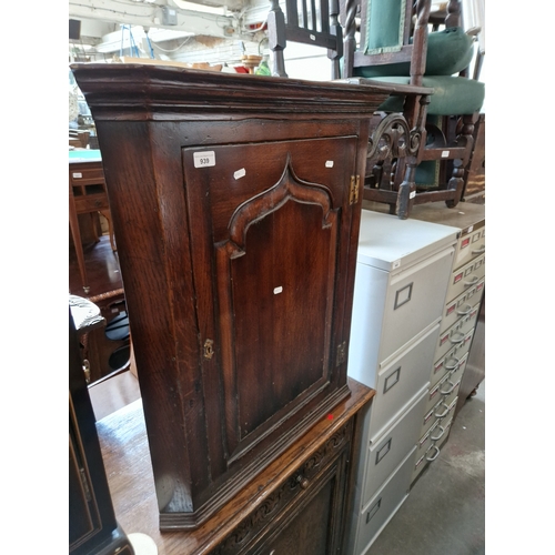 939 - A Georgian oak corner cabinet.