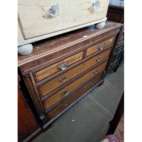 949 - A George III oak chest of drawers, standing on bracket feet.