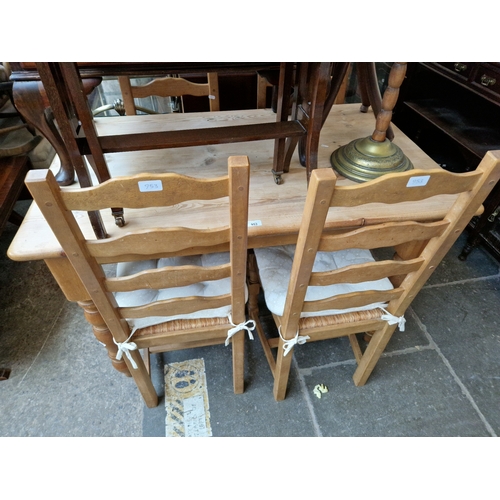 953 - A pine kitchen dining table and four chairs.