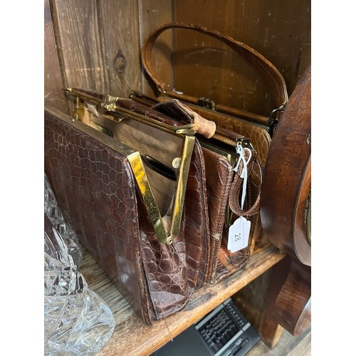 28 - Three vintage handbags and a silver backed hairbrush