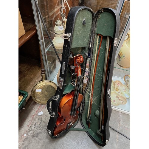 71 - A Chinese violin in case with 2 bows