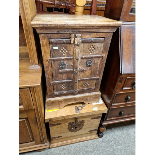 973 - A rustic hardwood cabinet and a metal bound pine box.