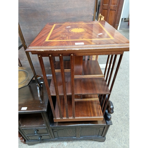 976 - An inlaid mahogany revolving bookcase.