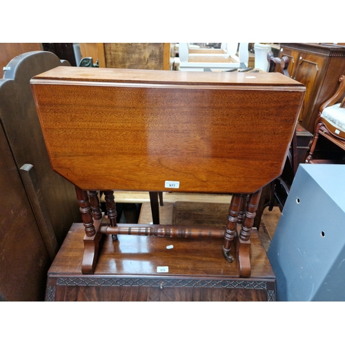 977 - An Edwardian walnut Sutherland table.