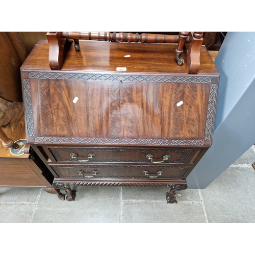 978 - An early 20th century mahogany bureau on ball and claw feet.