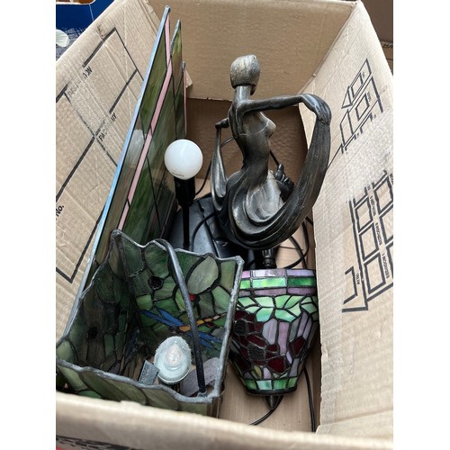 206 - A box of Tiffany style lamps, a metal figure of a lady and a piece of leaded glass.