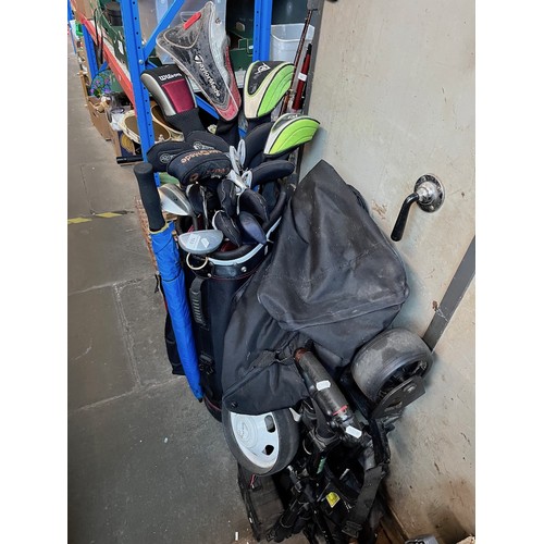 103 - A Wilson golf bag containing various golf clubs and an electric trolley with battery