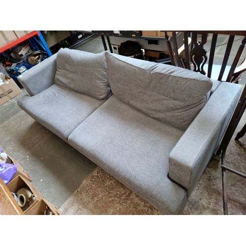 992 - A modern grey sofa with chrome legs.