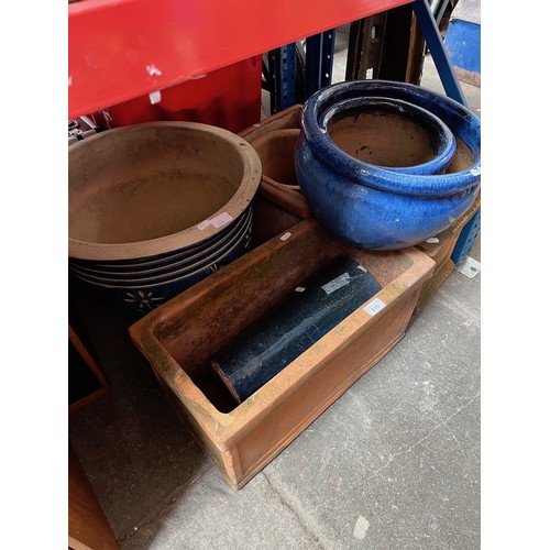 215 - A terracotta trough, 2 square terracotta planters, a terracotta plant pot and 3 glazed plant pots an... 