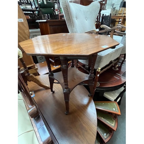 919 - An Edwardian walnut octagonal top two tier occasional table.