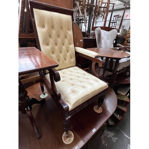 916 - A 19th century mahogany armchair with slide out footstool, upholstered in cream leather.