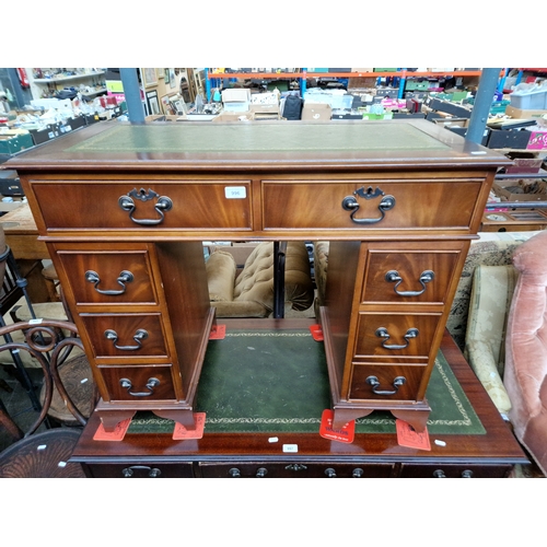 996 - A mahogany kneehole desk of small proportions.