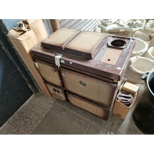 1039 - A Stanley 'SuperStar' cast iron solid fuel cooker, together with a pallet truck.