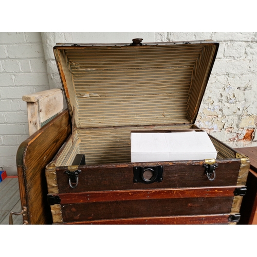 113 - A domed trunk and contents including a tray, a wash board, 1930s china, meat plates, dishes.