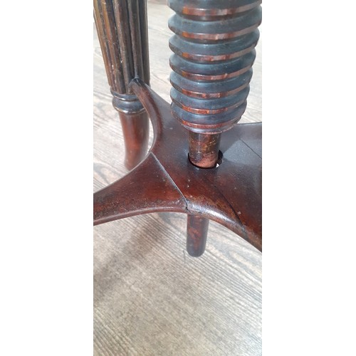 1012 - A 19th century inlaid rosewood adjustable piano stool.