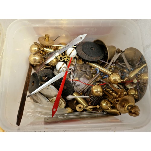 143 - A box of clock parts including cast metal figures, movements, weights etc.