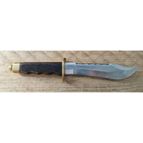 67 - A fixed blade bowie knife with wooden handle, brass guard and pommel, marked on blade 440 Stainless.