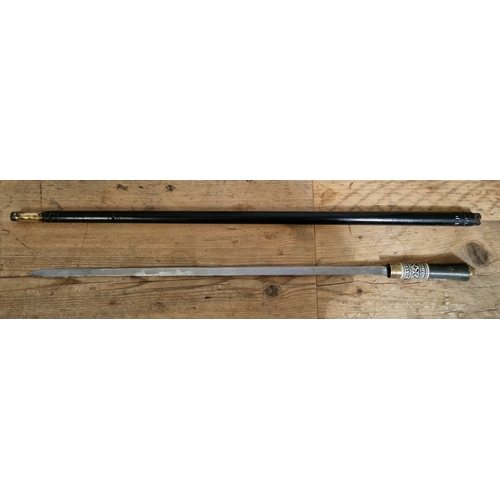 70 - A sword stick with carved bone handle and locking mechanism, ebonised wood with brass tip and brass ... 