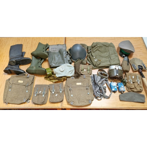 80 - Various items of East German militaria including leather jackboots, various items of clothing, caps,... 