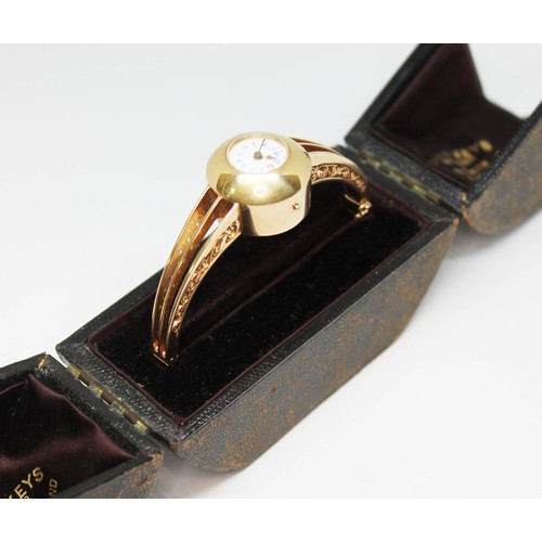 44 - A late Victorian/Edwardian ladies bangle watch, white enamel dial with outer gold dot minutes, blue ... 