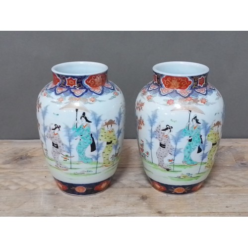 115 - A pair of Japanese 19th century porcelain vase, decoration depicting figures, height 24cm.