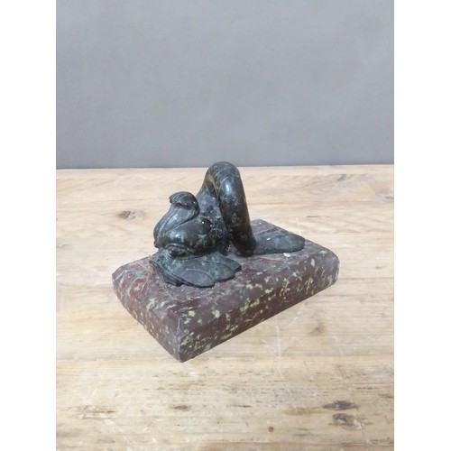 112 - A 19th carved hard stone door stop modelled as a mythical dolphin on platform base, length 16.5cm.