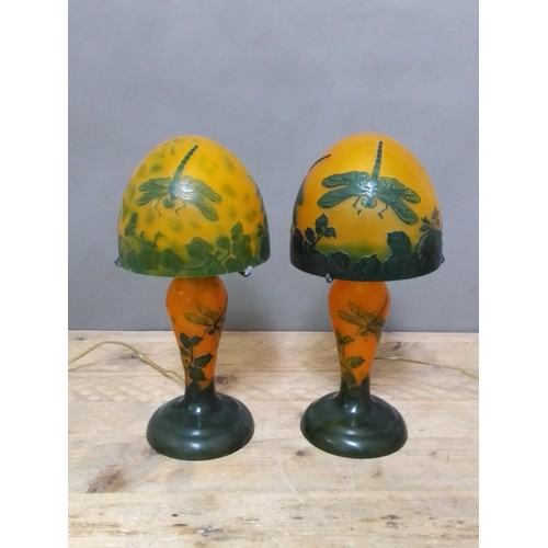 103 - A pair of reproduction Galle style mushroom lamps, in orange and green and decorated with dragonflie... 