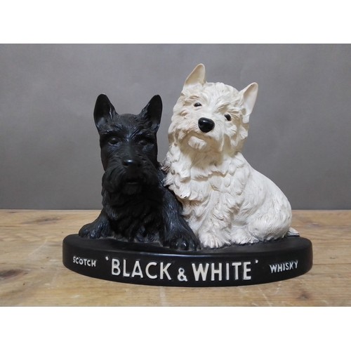 102 - A Scotch 'Black & White' Whisky advertisement bar figure, length 27cm.