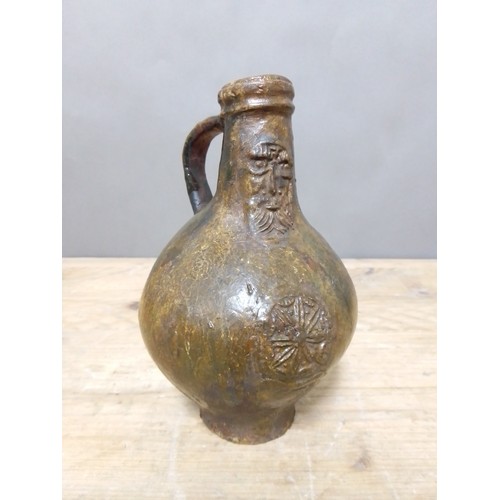 140 - A 17th century Bartmann jug, height 20.5cm.