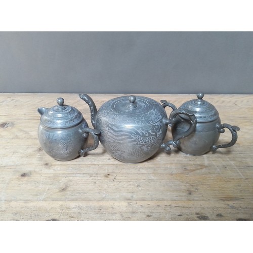 180 - A Chinese three piece pewter tea set.