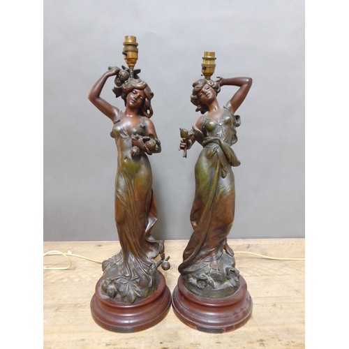 150 - A pair of Art Nouveau patinated spelter lamp bases after Moreau, height 64cm.