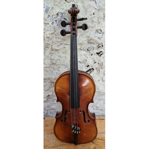 208 - A German violin, labelled 'Copy of Antonius Stradivarius', two piece back, length 395mm, with case.