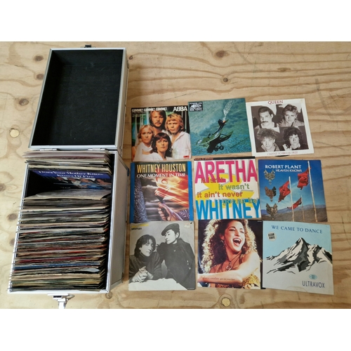 210 - A hard aluminium case containing various vinyl singles to include John Lennon, Queen, Abba, etc.