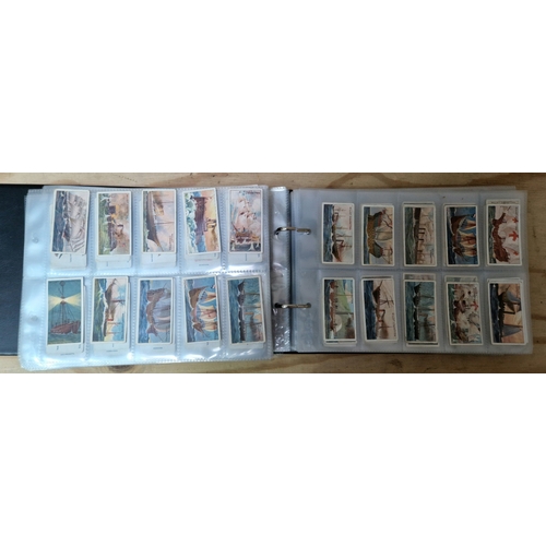 218 - A folder of cigarette cards, full sets and some loose.