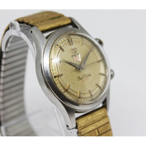 10 - A Paul Buhre stainless alarm wristwatch, circa 1950s, case diam. 30mm, champagne dial, 17 jewel manu... 