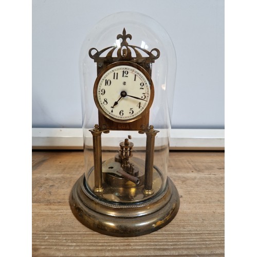 283 - A Badische torsion clock under glass dome, height 29cm, with key.