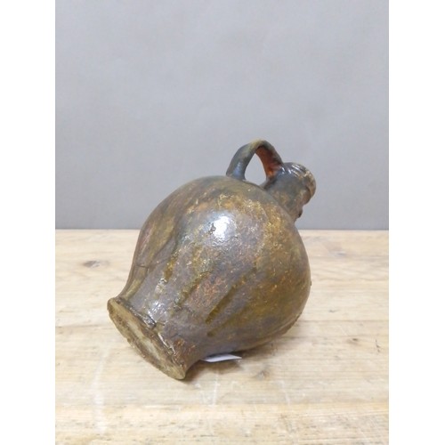 140 - A 17th century Bartmann jug, height 20.5cm.