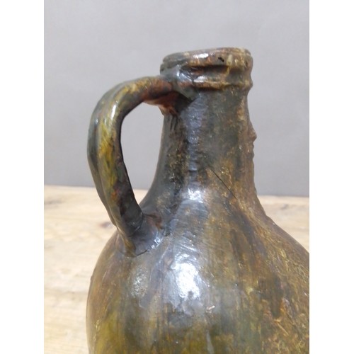 140 - A 17th century Bartmann jug, height 20.5cm.