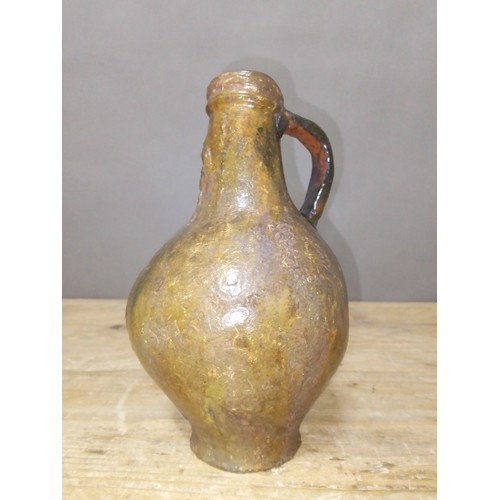 140 - A 17th century Bartmann jug, height 20.5cm.