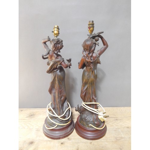 150 - A pair of Art Nouveau patinated spelter lamp bases after Moreau, height 64cm.