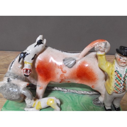 184 - A box of assorted Staffordshire pottery cow figures.