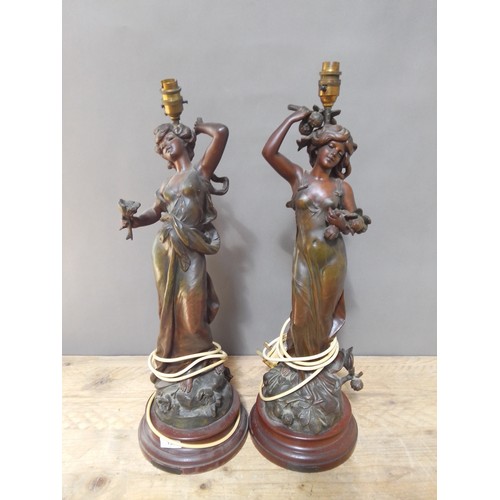 150 - A pair of Art Nouveau patinated spelter lamp bases after Moreau, height 64cm.