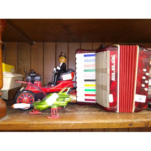 13 - A child's accordion, a tin plate car and Thunderbirds die-cast model.