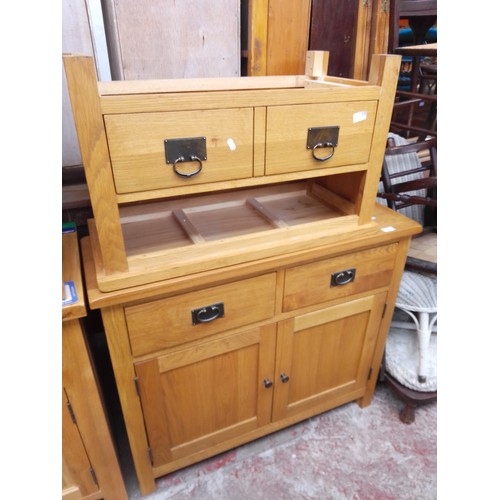 779 - A light oak cabinet and TV stand.