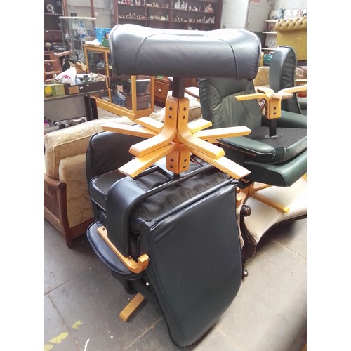 771 - A pair of navy faux leather swivel chairs with matching stools.