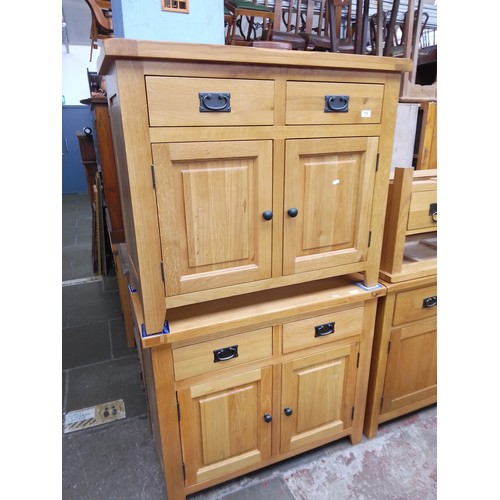 778 - Two light oak cabinets.