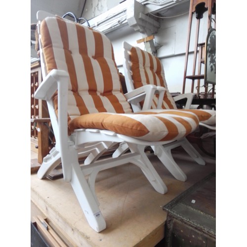 806 - A pair of white plastic garden sun lounger/chairs.