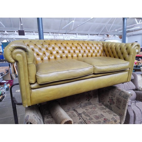 765 - A mustard leather chesterfield settee.